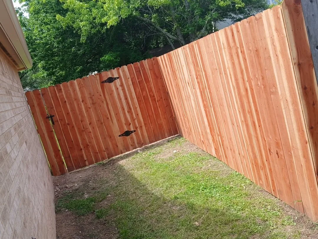 New cedar privacy fence turning a corner at the back of a house